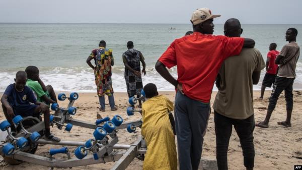 Family members, friends and community members gather along the beach as they wait for search and rescue teams to find survivors and retrieve the dead after a boat carrying migrants sunk off Mbour, Senegal, on Sept. 9, 2024. 